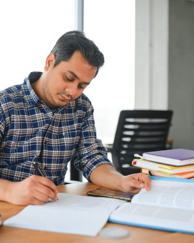 Portrait of cheerful male international Indian student with backpack. Education concept.