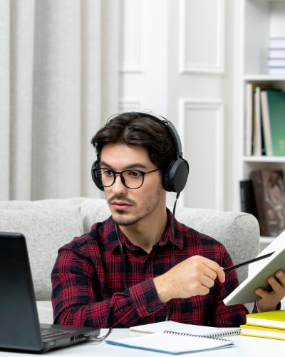 student-online-cute-guy-checked-shirt-with-glasses-studying-computer-reading-book